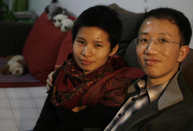Human rights activists Hu Jia (R) and his wife Zeng Jinyan (L) during their house arrest, monitored by police and internal security police, in their housing complex ironically named Bobo Freedom City.   (Frederic J. Brown/AFP/Getty Images)