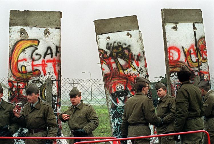 East German border guards demolishing a section of the Berlin wall in order to open a new crossing point between East and West Berlin at the border line near the Potsdamer Square on Nov. 11 1989. (Gerard Malie/AFP/Getty Images)