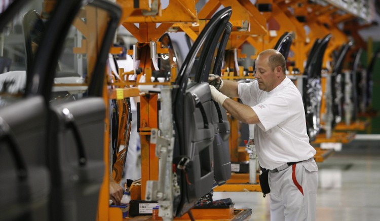 In this file photo, a plant worker is seen assembling Audi car doors at the company's plant in Brussels, Belgium. Audi is in the process of setting up a production plant in Mexico to meet higher demand. (Benoit Doppagne/AFP/Getty Images) 