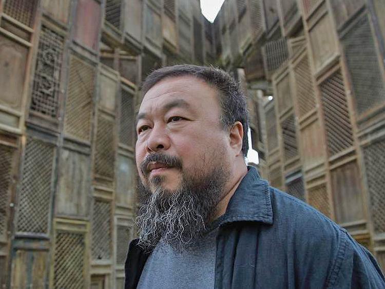 Chinese Artist Ai Weiwei poses in front of his sculpture, 'Template.' Weiwei disappeared by the authorities on April 3, and is reported to have confessed to charges of tax evasion after being tortured in custody. (Simon/Getty Images)