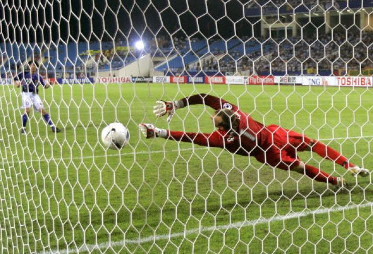Japanese Shunsuke Nakamura (L) scores as Australian goalkeeper Mark Schwarzer (R) attempts to save the ball during their quarter-final match of the Asian Football Cup in Hanoi, July 21 2007. Japan won a tense 5â��4 penalty shootout to beat a desperately u (Liu Jin/AFP/Getty Images )