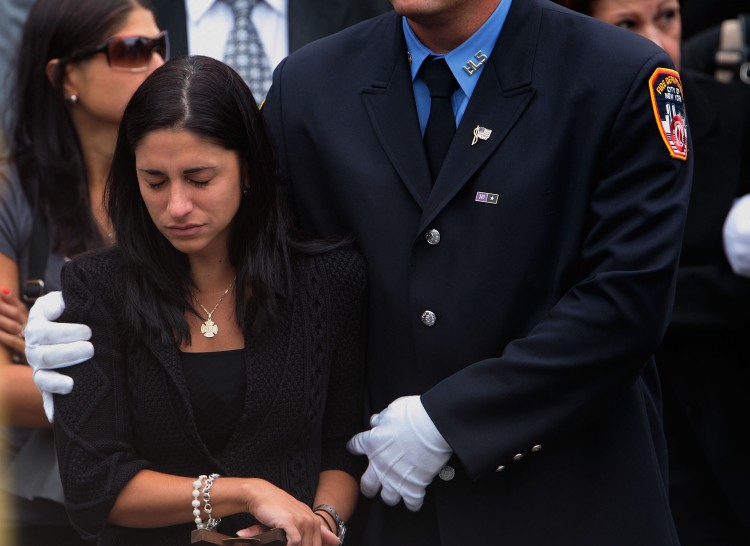 Linda Graffagnino is escorted by a New York firefighter