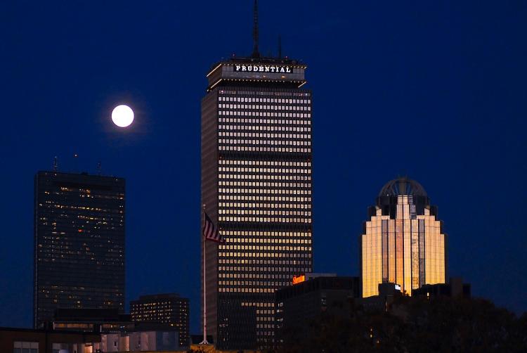 DIGITAL FRIENDLY: A rising moon is seen behind the Prudential Building (C), part of the downtown Boston skyline. According to the Center for Digital Government Boston is ranked the No. 1 as the most digital city in the U.S.   (Darren McCollester/Getty Images)