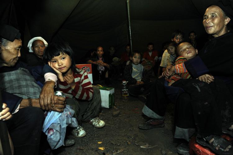 Villagers from a neighboring village where mudslide hits stay in a tent after evacuating from their homes. (The Epoch Times Archive   )