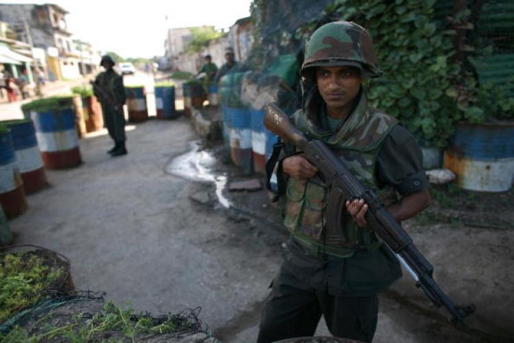 A Sri Lankan military officer stands at a checkpoint in a region torn by ethnic violence. (Pedro Ugarte/AFP/Getty Images)