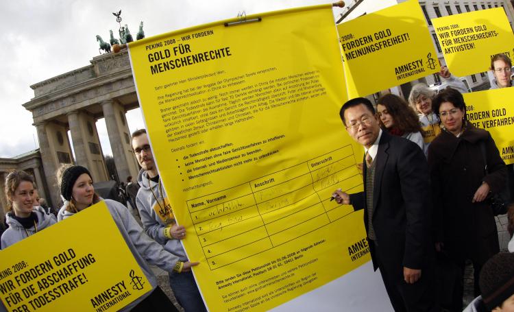 Biao Teng (L) signs a giant petition for human rights in China (Marcus Brandt/AFP/Getty Images)