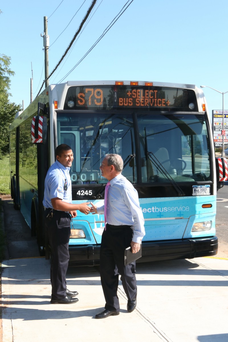 Mayor Michael Bloomberg (R) shakes hands with a bus driver next to the S79SBS bus in Staten Island on Thursday. The new express bus service will cut the number of stops from 80 to 22 end-to-end on Hylan Boulevard's S79 route. (photo courtesy of the Mayor's Office)