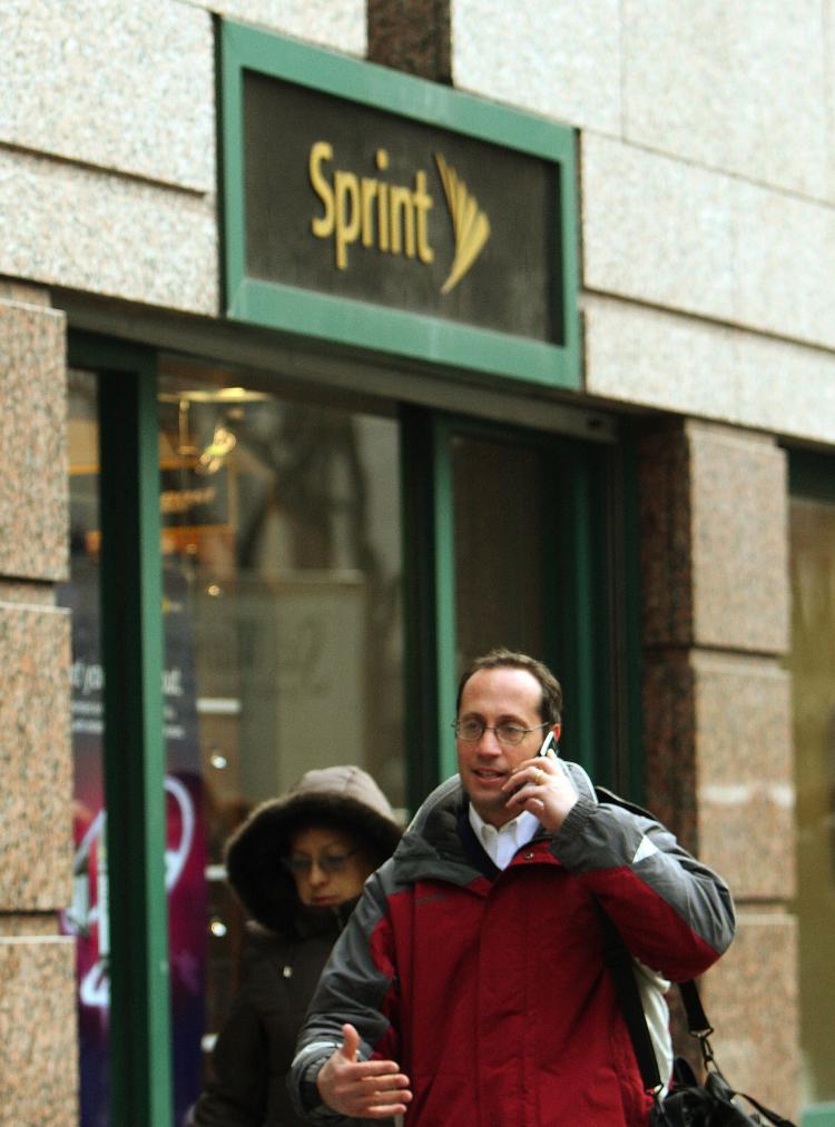 4G Phones: A man talks on a cell phone as he walks past a Sprint store on 42nd Street 15 January, 2008 in New York. (Don Emmert/AFP/Getty Images)