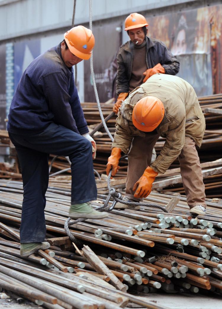 Construction workers prepare steel reinforcing rods at a building site in Shanghai, 2008.  (Mark Ralston/AFP/Getty Images)