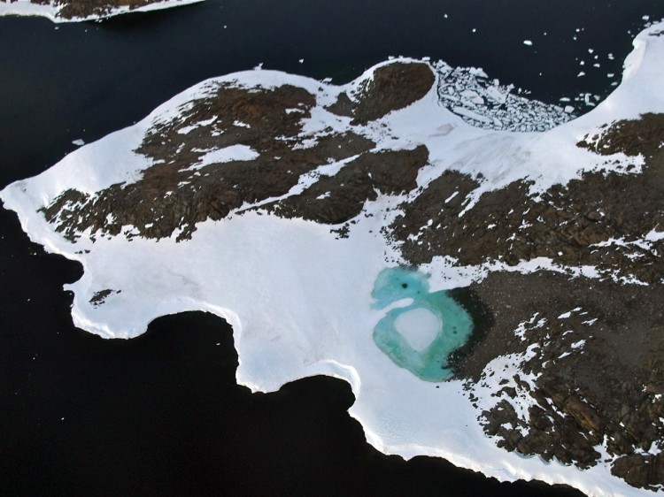 A turquoise lake (C) forms from melting snow on the Budd Coast, on Jan. 11, 2008, in the Australian Antarctic Territory.  (Torsten Blackwood/Getty Images)