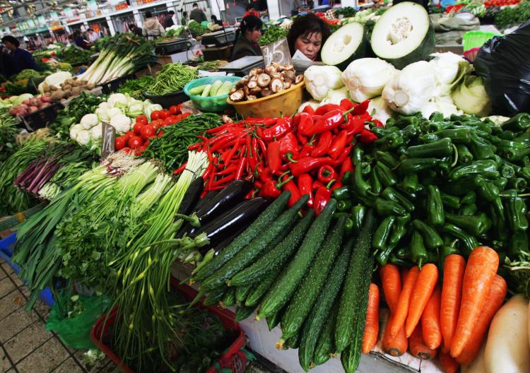 A vendor sells vegetables at a market in Wuhan, Hubei Province, China. Industry experts predict that the vegetable price peak has not yet come. (China Photos/Getty Images)