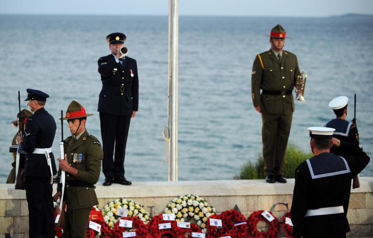 Australian soldiers stand guard as as a bugle is played during a dawn ceremony at Anzac Cove where the first battle was fought in Gallipoli. (Burak Kara/Getty Images)