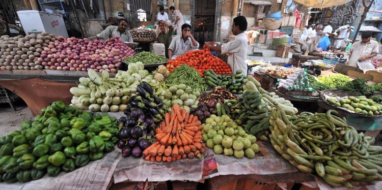 Pakistani vegetable vendors wait for customers at a market in Karachi. (RIZWAN TABASSUM/AFP/Getty Images)