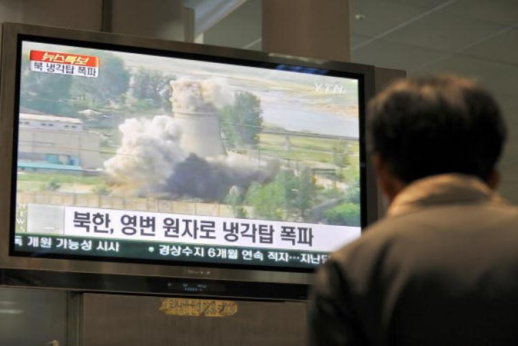 A TV screen showing footage of the public demolition of North Korea's cooling tower at its Yongbyon nuclear complex in Seoul on June 27, 2008. North Korea blew up the cooling tower to symbolise the communist state's commitment to scrapping its nuclear programme. (Jung Yeon-Je/AFP/Getty Images)