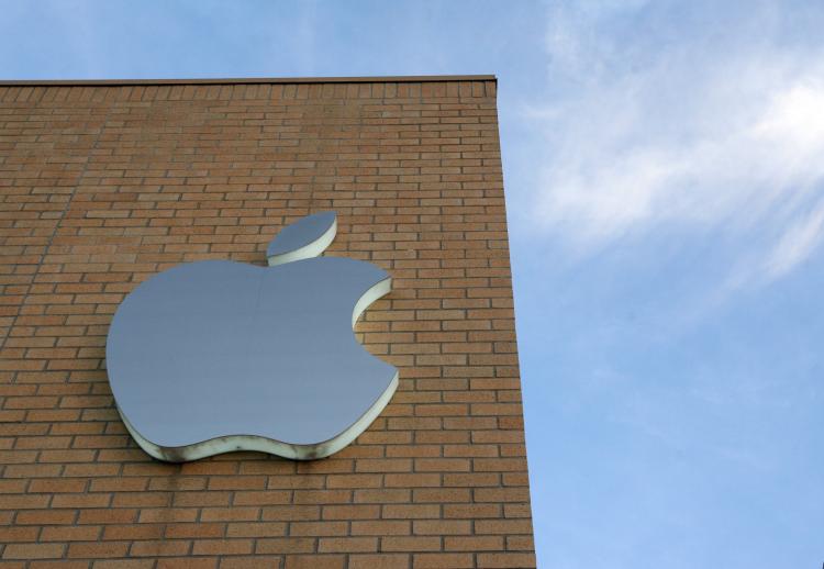 The Apple logo is illuminated on the side of the Apple Store at daybreak July 11, in Dallas, Texas. Apple release it's 2nd generation iPhone today called the iPhone 3G. (Rick Gershon/Getty Images)