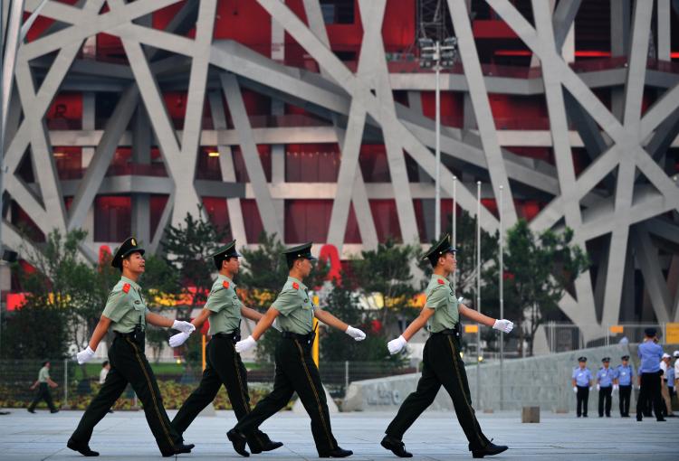 Chinese paramilitary soldiers march outside the main Olympic Stadium, also known as the Bird's Nest, in Beijing. (FREDERIC J. BROWN/AFP/Getty Images)