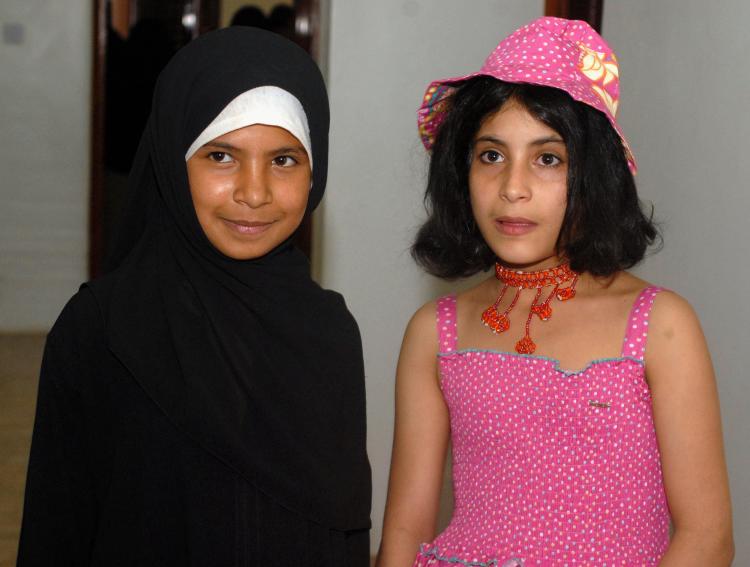 Yemeni child brides, Nujood Ali (L) and Arwa (R), pose for a picture as they celebrate their divorces, granted them by a Yemeni court in the capital Sana'a on July 30, 2008. (Khaled Fazaa/AFP/Getty Images)