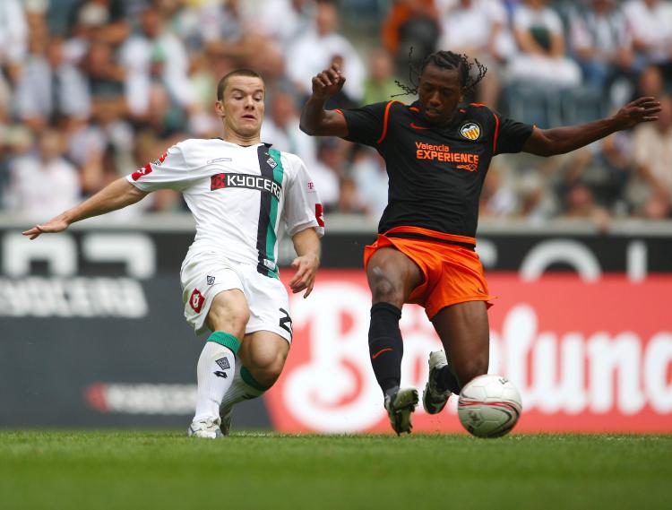 Borussia Mönchengladbach player Alexander Baumjohann (left) and his team in preseason action against Valencia of Spain. The real season begins Friday in Germany. (Christof Koepsel/Bongarts/Getty Images)