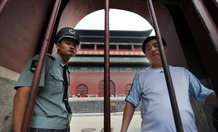 A security guard blocks access to the historic Drum Tower where a U.S. citizen was murdered in Beijing.  (Mark Ralston/AFP/Getty Images   )