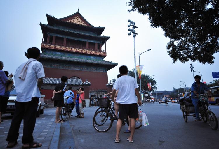 People gather outside Beijing's ancient Drum Tower on August 9, 2008 in Beijing, where a relative of a US Olympic coach was killed and another injured in a stabbing attack earlier in the day. (Frederic J. Brown/AFP/Getty Images)