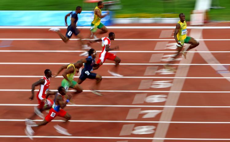 AUGUST 16: Usain Bolt of Jamaica (R) crosses the line on his way to winning the Men's 100m Final at the National Stadium on Day 8 of the Beijing 2008 Olympic Games (Rys/Bongarts/Getty Images)