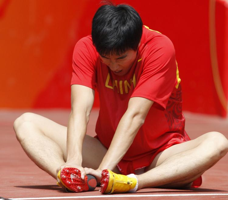 China's Liu Xiang retires from the first round of the men's 110m hurdles at the 'Bird's Nest' National Stadium during the 2008 Beijing Olympic Games. (Adrian Dennis/AFP/Getty Images)