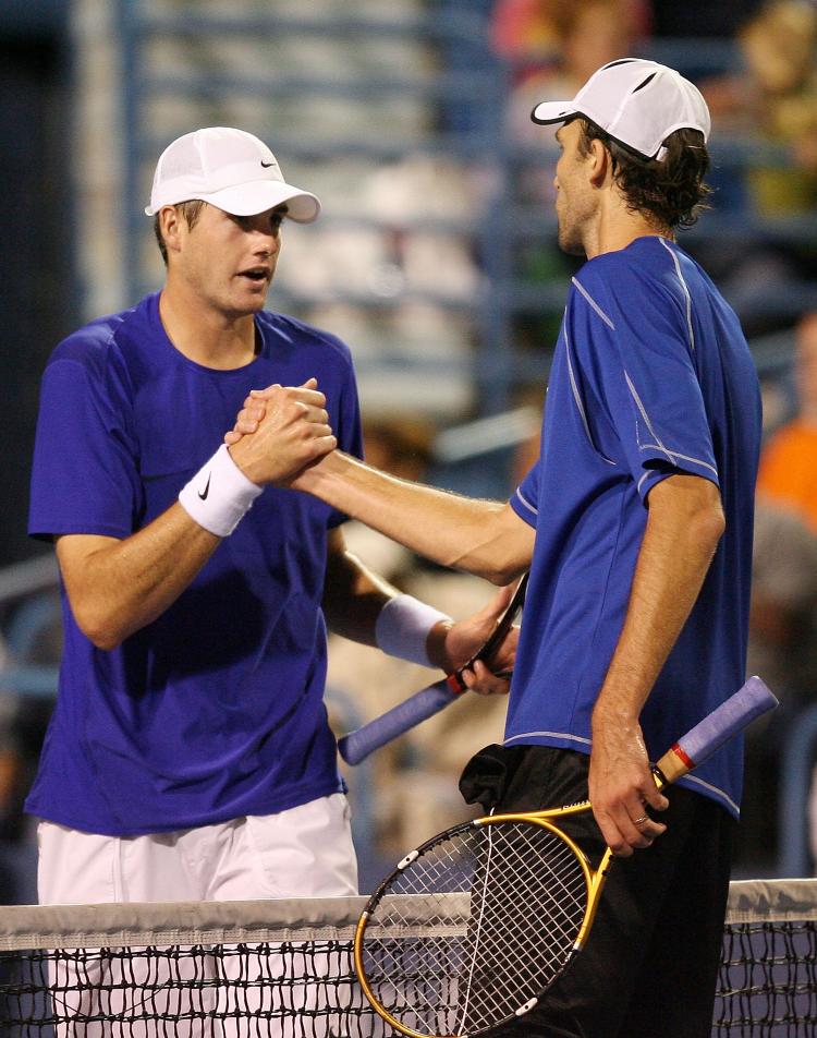 John Isner (left) congratulates his taller opponent Ivo Karlovic after a hard-fought match. (Elsa/Getty Images)