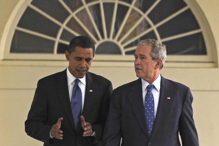 US president-elect Barack Obama is led by US President George W. Bush (R) through the Colonnade during a welcome ceremony at the White House in Washington, DC, November 11, 2008. (Jim Watson/AFP/Getty Images)