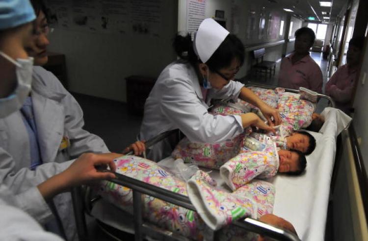 A nurse checks the name tag on newborn babies after they are given a bath and returned to their parents at a hospital in Beijing. A World Health Organization report shows that between October 2007 and May 2008, 46 percent of births in China were by Cesarean section. (Frederic J. Brown/Getty Images)