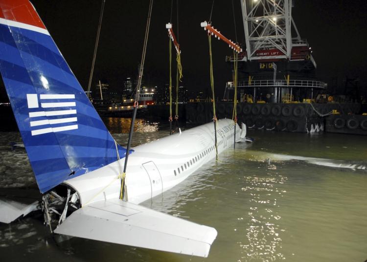 US Airways flight 1549 known as the 'the Miracle on the Hudson,' being removed from its makeshift mooring along a seawall in lower Manhattan January 17, 2009.  (Gluck-Pool/Getty Images)