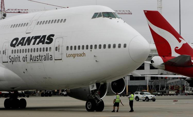 A Qantas Boeing 747 is seen sitting at the Sydney International Airport. Qantas, Australia's flag carrier, is one of more than a dozen airlines fined for cargo price fixing.