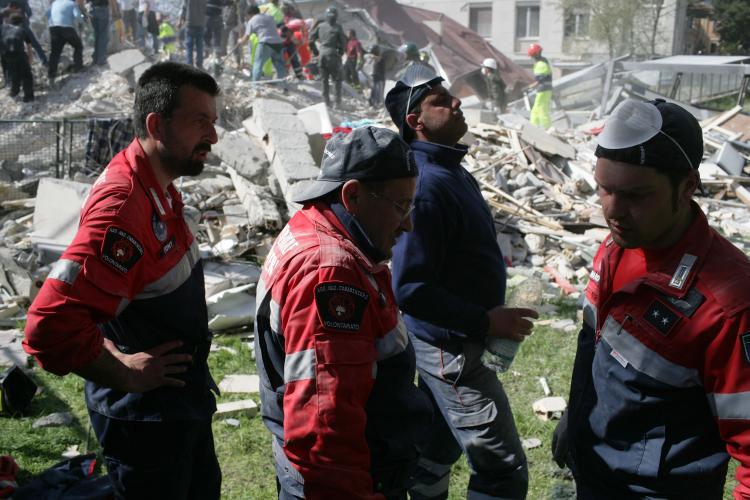 Rescue workers at the scene following an earthquake on April 6, in L'Aquila, Italy. The 6.3 magnitude quake tore through central Italy, devastating historic towns, killing at least 9150 people and injuring some 1500. (Marco Di Lauro/Getty Images)