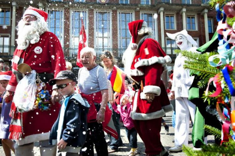 Participants, wearing Santa Claus and pixies costums, dance around the Christmas tree on the second day of the World Santa Claus Congress 2009 in Copenhagen on July 21, 2009.  (Casper Christoffersen/AFP/Getty Images)
