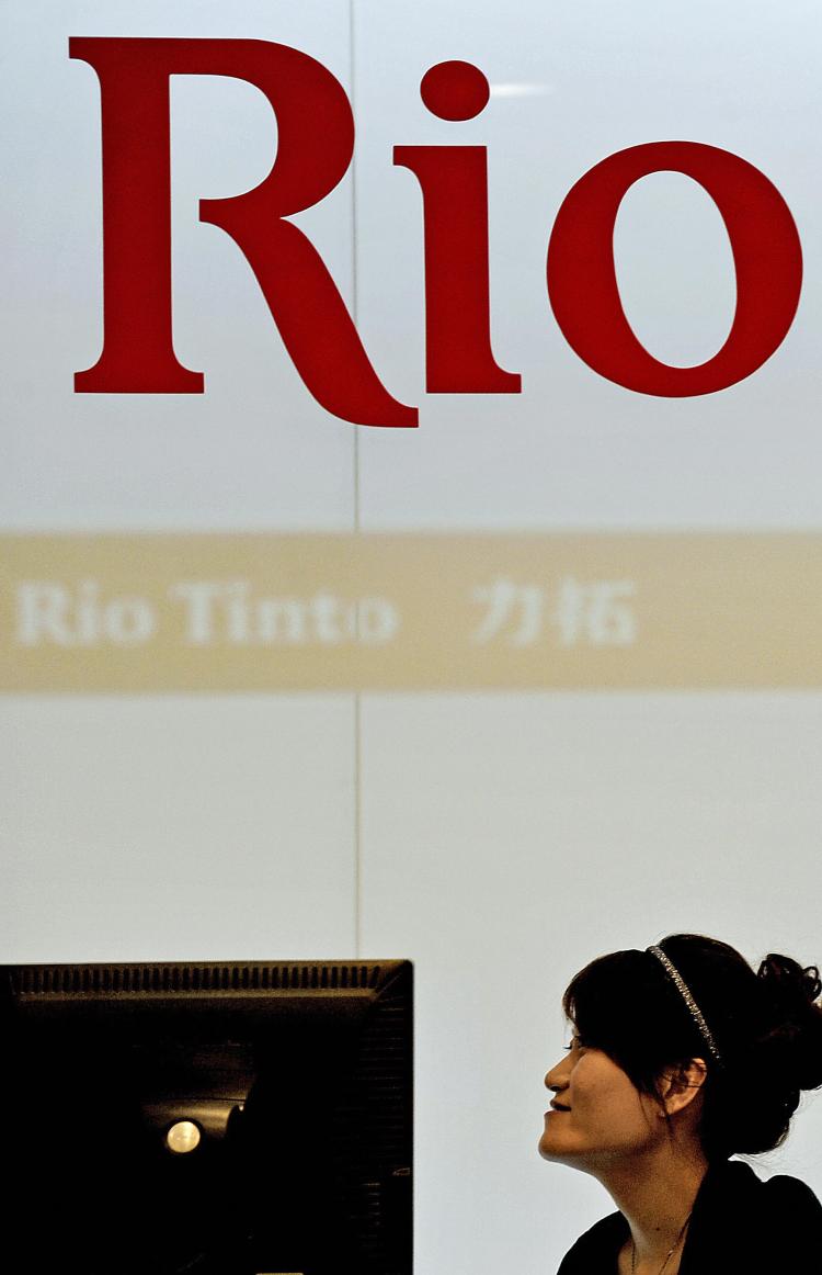 An employee sits at the reception desk of the offices of Australian mining giant Rio Tinto in Shanghai on August 12, 2009. Rio has been at the center of a political storm with the recent arrests.  (Philippe Lopez/AFP/Getty Images)
