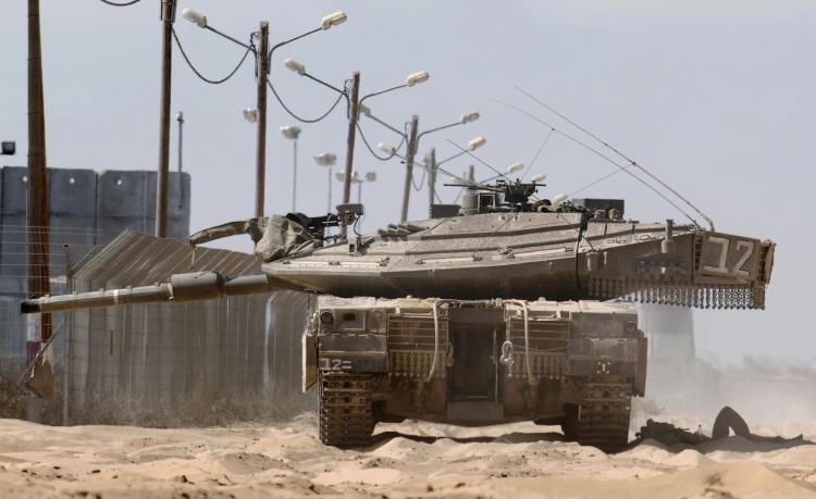 The Kerem Shalom border crossing where two Israeli teenagers were returned from Egypt Monday. Photo shows Israeli soldiers rest at the shadow of their tank at the crossing on the border with the southern Gaza Strip in August 2009.  (DAVID BUIMOVITCH/AFP/Getty Images)