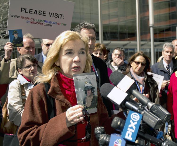 Sally Regenhard (L) gathered with family members of firefighters and other 9/11 victims outside the World Trade Center on Sunday to protest placing remains of their loved ones in the basement of the 9/11 museum.  (Phoebe Zheng/The Epoch Times)