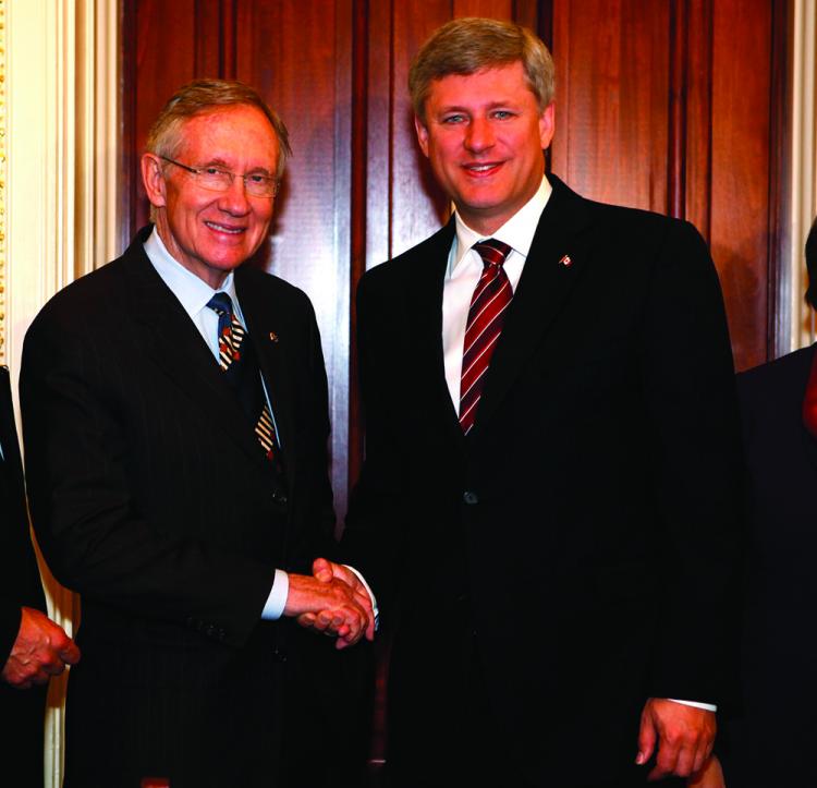 U.S. Senate Majority Leader Harry Reid shakes hands with Prime Minister Stephen Harper during a meeting on Sept. 17, 2009, on Capitol Hill. A report co-authored by a Canadian professor shows the U.S. Congress has mixed attitudes toward Canada. (Alex Wong/Getty Images)