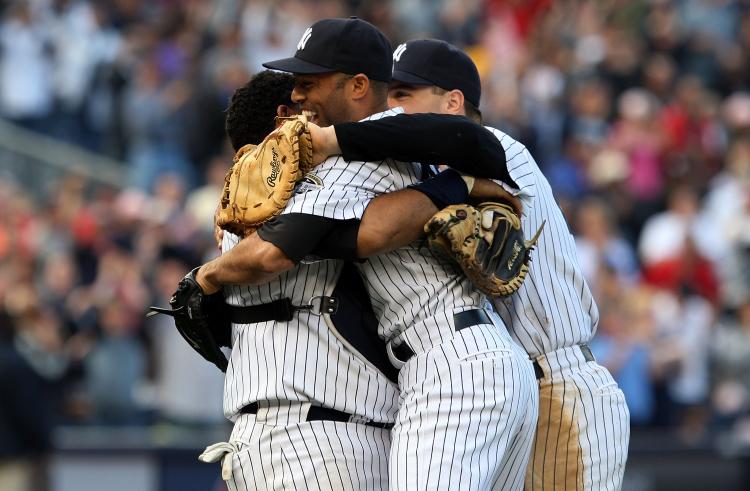 DIVISION CHAMPS: Mariano Rivera, Jose Molina, and Mark Teixeira celebrate after defeating Boston and clinching the AL East.  (Jim McIsaac/Getty Images)