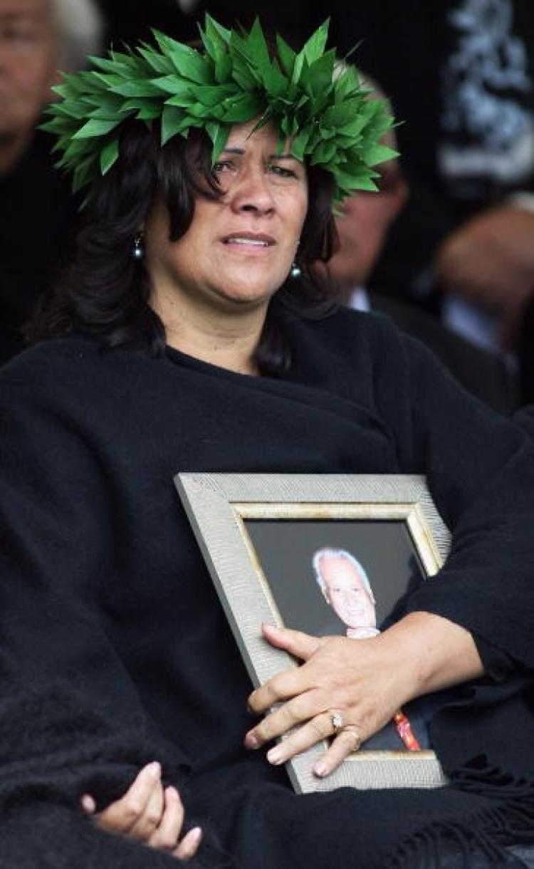 A photo of Sir Howard Morrison is held by his daughter Donna Grant during the burial of Sir Howard Morrison at the Kauae cemetery on September 29, 2009 in Rotorua, New Zealand. (Hannah Johnston/Getty Images)
