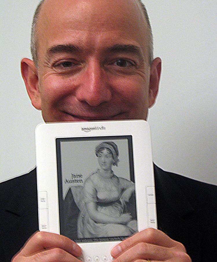 Amazon.com founder and chief executive Jeff Bezos holds an international Kindle electronic book reader, designed to make digital works easy to download wirelessly in countries around the world. (Glenn Champman/AFP/Getty Images)