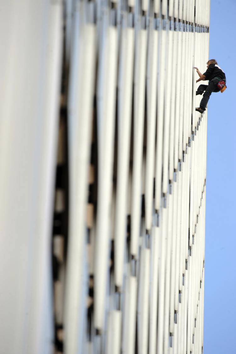 French climber Alain Robert, a.k.a. 'Spiderman,' will climb the new Burj Khalifa in Dubai. Here, Robert climbs the front of the Ariane building, a 755 foot tower, on Oct. 8, 2009 in La Defense, outside Paris. (BORIS HORVAT/AFP/Getty Images)