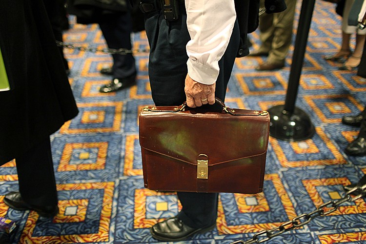 A man holds his briefcase while in line at a job fair sponsored by Monster.com that attracted hundreds of people on November 6, 2009 in New York City. (Spencer Platt/Getty Images)