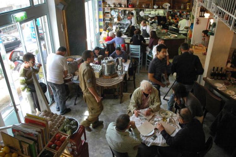 Israeli and foreigners eat at a busy 'MahneYuda', a recently opened gourmet non-Kosher restaurant, in Jerusalem's landmark Mahne Yehuda market. (Marina Passos /Getty Images)