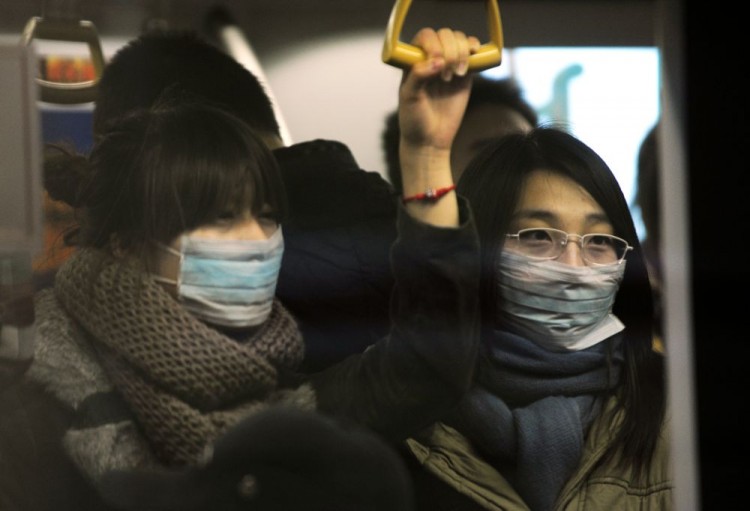 Two women wear masks while riding on the Beijing subway. (Peter Parks/AFP/Getty Images)
