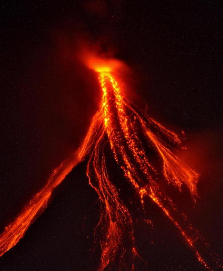 Lava cascades from the slopes of Mayon volcano in the Philippines southeast of Manila on December 23, 2009. Geologists are on frantic runs to monitor possible volcano eruptions throughout the world. (Ted Aljibe/Getty Images)