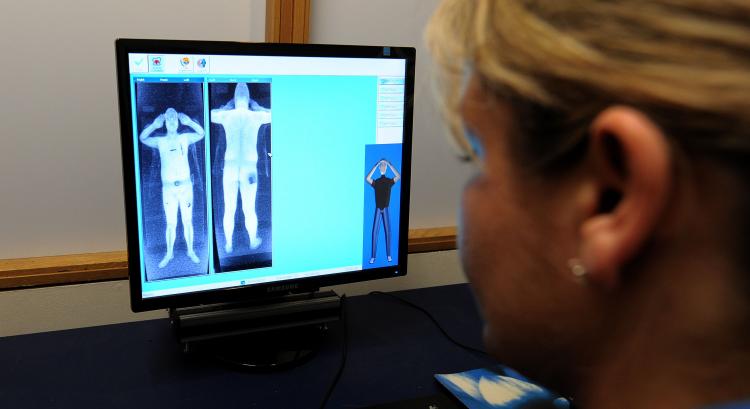 A Security officer views images from a body scanner. As part of new aviation security measures, Canada plans introduce full-body scanners at eight airports across the country. (Andrew Yates/AFT/Getty Images) A Security officer views images from a body scanner. As part of new aviation security measures, Canada plans introduce full-body scanners at eight airports across the country. (Andrew Yates/AFT/Getty Images)