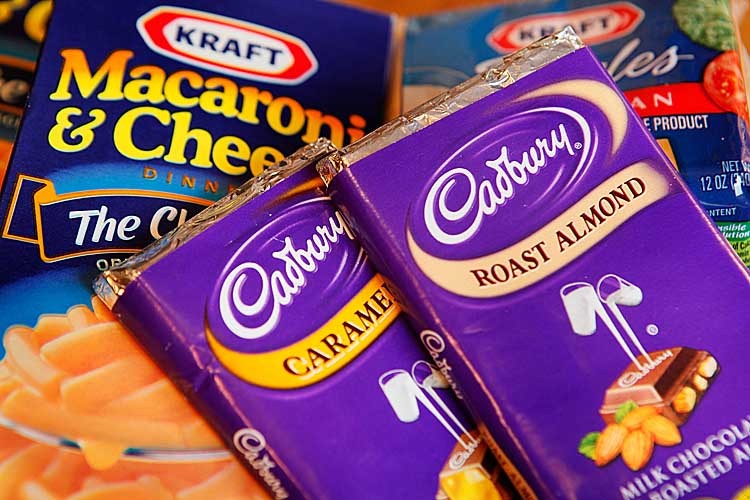 BREAKING UP: Kraft Macaroni & Cheese and Cadbury chocolate are displayed in this 2010 photo illustration. Kraft announced Thursday that it is breaking up its business into two separate public companies - one focusing on candy and the other on grocery products. (Scott Olson/Getty Images)