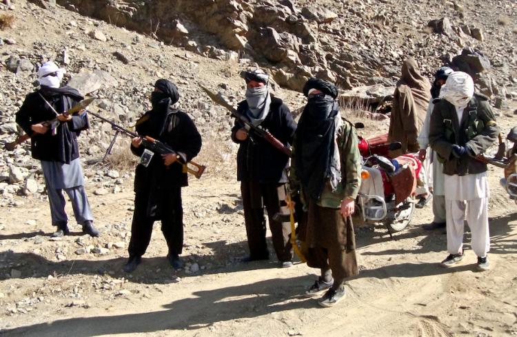 COMPLEX WAR: Taliban fighters stand alert during a patrol in Ghazni Province on Jan. 23. Jere Van Dyk, author of 'Captive: My Time as a Prisoner of the Taliban' was taken prisoner by the Taliban for 45 days in 2008.  (STR/Getty Images)