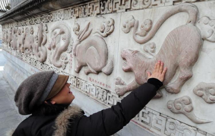 A bas relief sculpture of a tiger along a wall of bas relief sculptures depicting the 12 animals of the Chinese zodiac at the White Cloud Temple in Beijing. (Frederic J. Brown/AFP/Getty Images)