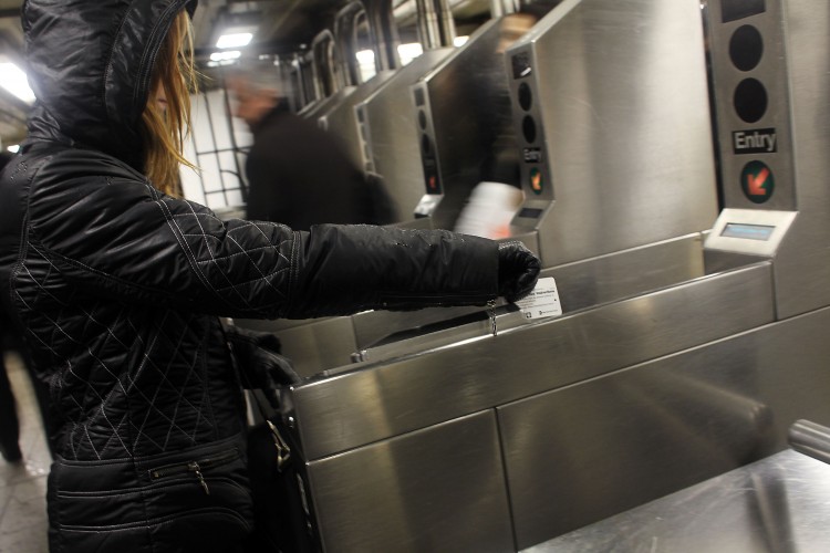 People swipe their metro cards in the New York City subway on February 23, 2010 in New York City. (Spencer Platt/Getty Images)